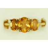 A 9ct gold and citrine three stone ring, R, 2.7gm