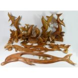 A collection of hand carved model sculptures, primarily depicting Dolphin's, together with a