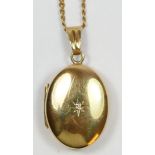 A 9ct gold diamond set oval locket, 20 x 14mm, chain (broken), 7gm
