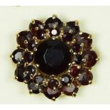 A 9ct gold (marks worn), and garnet cluster ring, overall diameter 20mm, 7.5gm, O