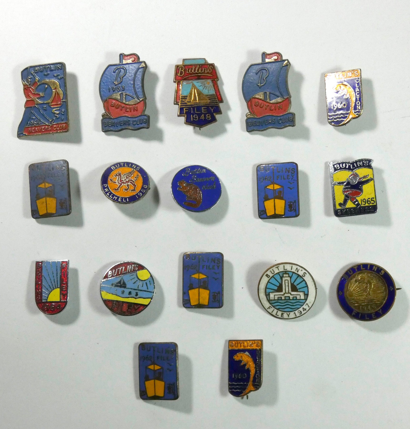 A collection of 17 Butlins metal and enamel badges, including Filey 1946, 47, 48, 62 x 4, 63 and 64,