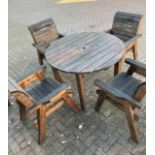 A substantial stained hardwood garden table and four carver chairs. (5) 115cm diameter.