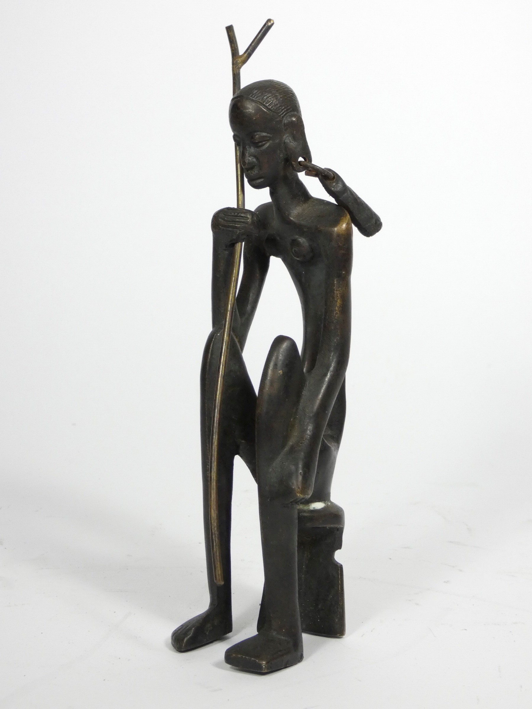 An African cast bronze figure of a seated woman, 21cm,