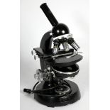 A Carl Zeiss microscope, with three objective lens, black with polished hardware, 40cm tall, with