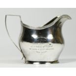 A George III silver presentation milk jug, London 1818, with later 1878 inscription, 101gm