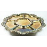 An electroplated Lazy Susan serving dish, with applied floral border, raised on a spreading foot,