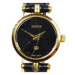 Gucci, a gilt metal and black enamel quartz ladies wristwatch, 22mm, recent battery, case