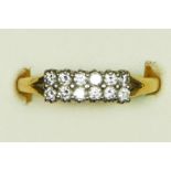 An 18ct gold two row diamond set ring, claw set with brilliant cut stones, approximately 0.6cts,