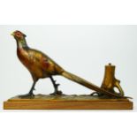 An Austrian cold painted spelter 'striker' table lighter in the form of a cock pheasant by a tree