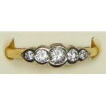 An 18ct gold and five stone diamond ring, collect set with graduated brilliant cuts stones, total