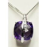 A 9ct white gold amethyst and diamond pendant, the briolette cut stone with a row of diamonds,