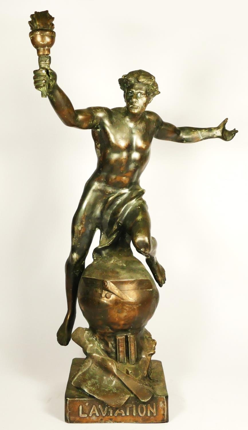 L'Aviation, an early 20th century bronzed spelter trophy/statue, depicting a youth holding a flaming