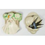 Clarice Cliff pottery wall pockets, circa 1940s, one modelled as a swallow in front of a cloud,