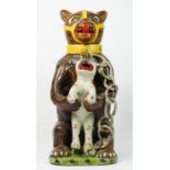 A bear baiting advertising jar and cover, modelled as a large bear clutching a snarling dog