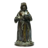 A bronze novelty match holder, in the form of a monk, hinged at the waist, striker on the ground,