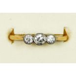 An 18ct gold three stone diamond ring, collet set with old cut brilliant stones, total weight