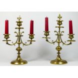 A pair of gilt brass twin sconce candlesticks, supported on four, these give way to a square stepped