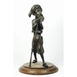 A bronzed spelter figure of a Middle Eastern gunman, oak base, 35cm