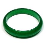 A jadeite bangle, untested for colour, internal diameter 60mm.