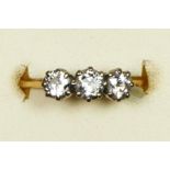 An 18ct gold three stone diamond ring, claw set with old cut stones, total weight approximately 0.