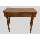 A Victorian mahogany rectangular fold over tea table, raised on four tapering turned supports.