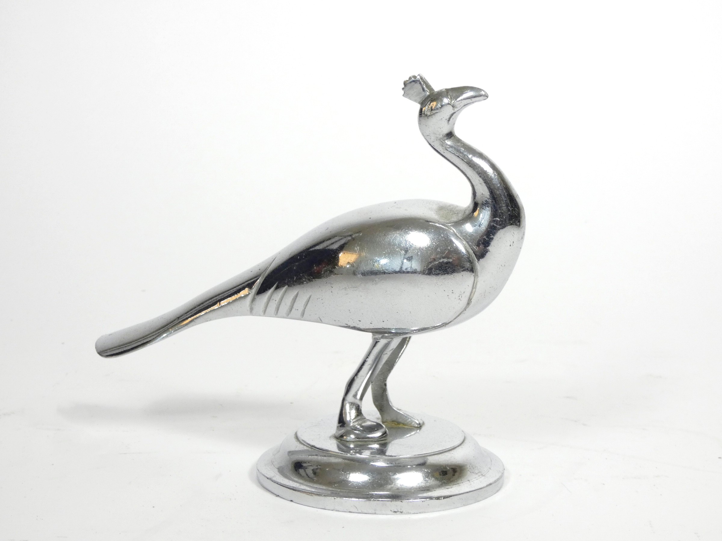 A vintage chrome car mascot, in the form of a peacock, signed T.C., 15 x 13cm