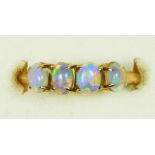 A 14k gold four stone opal ring, stamped 585, claw set with cabochon stones, M, 2.4gm