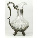 An electroplated and cut glass wine ewer, the cutglass body with floral scroll handle and scroll