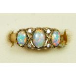 An Edwardian style 9ct gold three stone opal ring, diamond points between, K, 2.1gm.