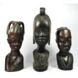 A West African carved hardwood bust of a lady, 38cm and two smaller examples, 31 and 27cm (3).