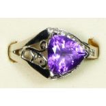 A 9ct white gold amethyst and diamond dress ring, the triangular cut stone flanked by brilliants,