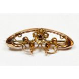 A Victorian 9ct rose gold garnet and half pearl floral scroll brooch, 33mm, 2.2gm