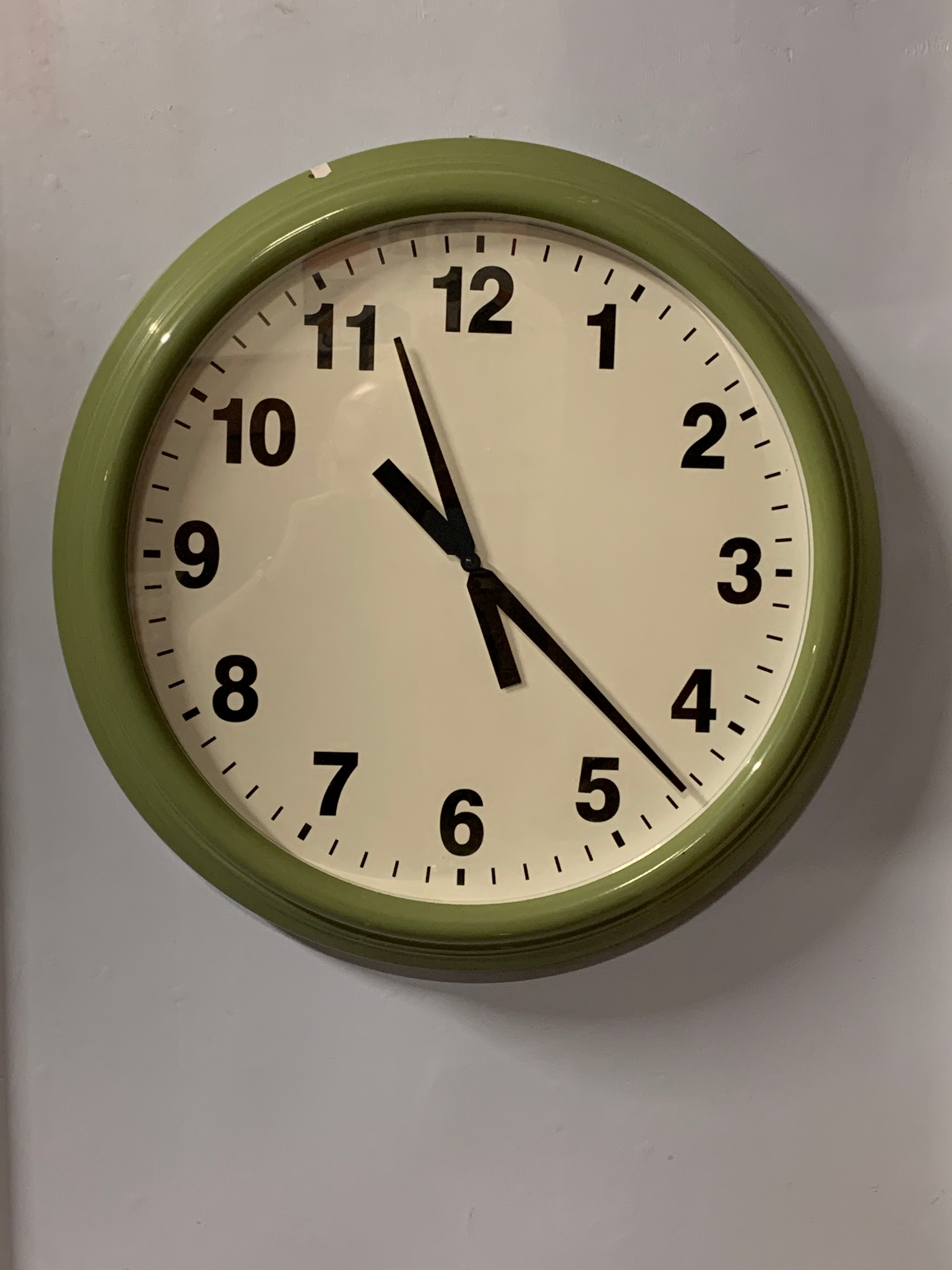 An Ikea 'Snugga' quartz wall clock, metal case with plastic front, white dial with Arabic