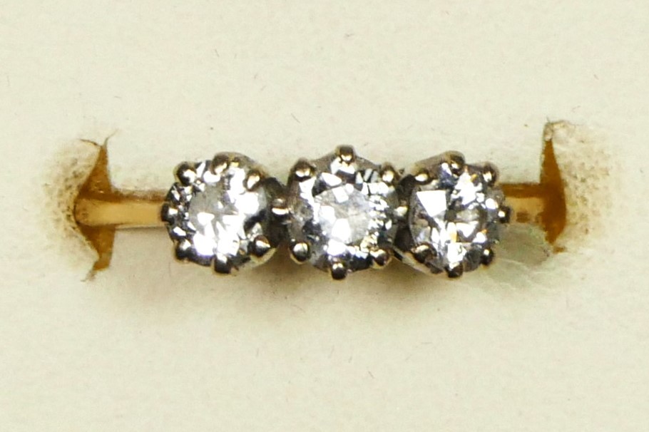 An 18ct gold three stone diamond ring, claw set with old cut stones, total weight approximately 0.