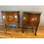 A pair of Louis XV style chest of two drawers, bombe shaped having walnut and mahogany veneer