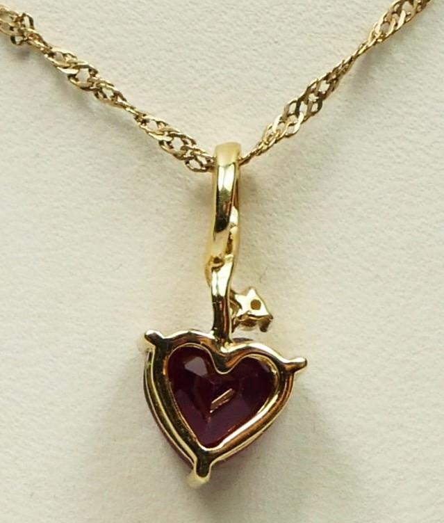 A 9ct gold heart shape ruby and brilliant cut diamond heart pendant, stone 7 x 7mm, 1.9gm - Image 2 of 2