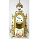 An early 20th century French gilt and porcelain inset mantel clock, having enamelled dial with Roman