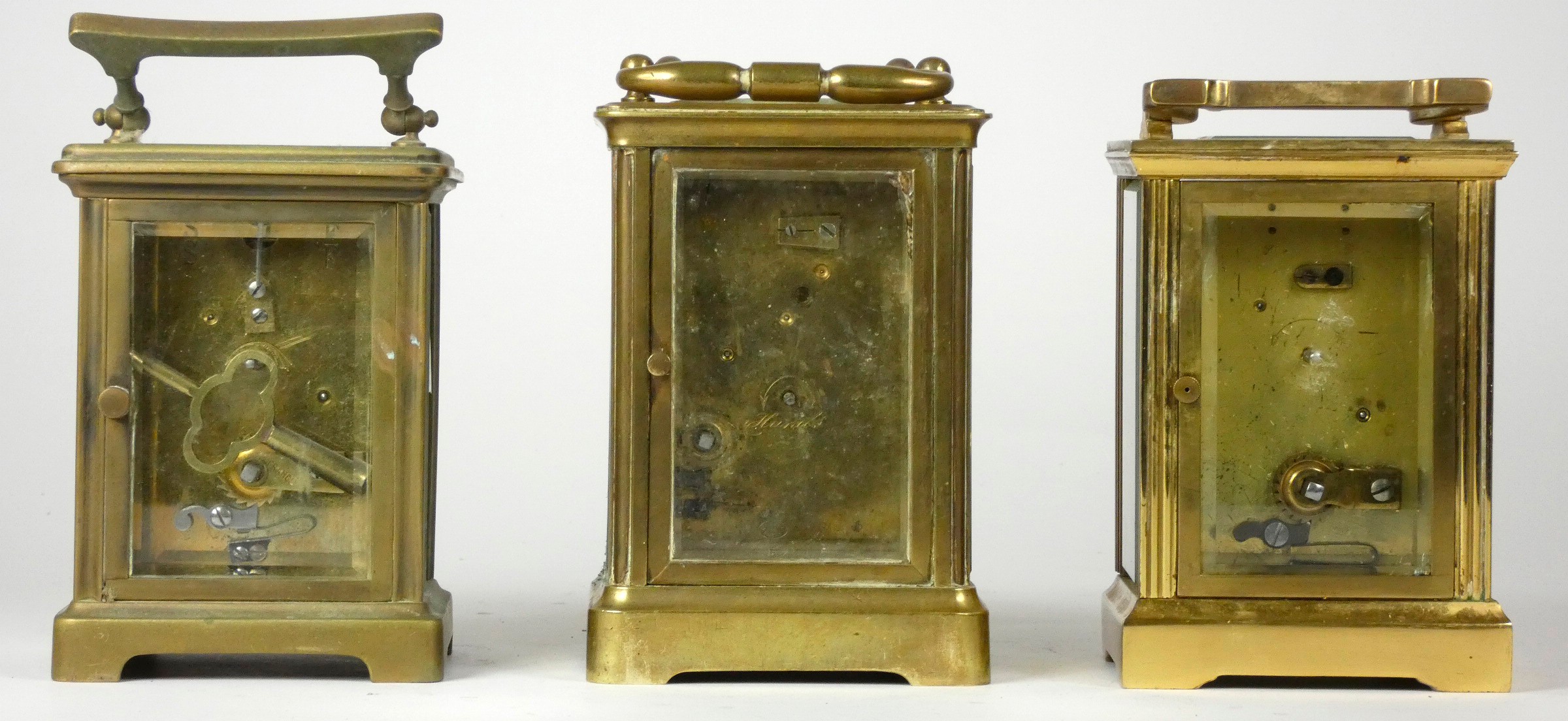 Three mid 20th Century carriage clocks, having 8 day movements, brass cased, enameled dials with - Image 3 of 3