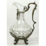 An electroplated and cut glass wine ewer, the cutglass body with floral scroll handle and scroll