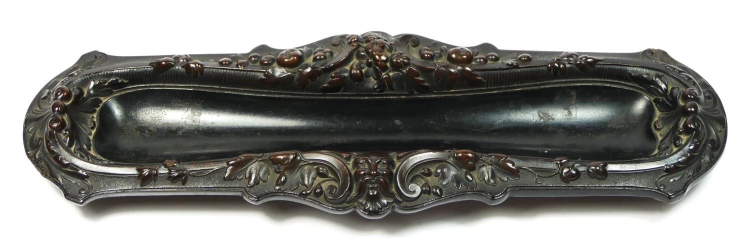 A 19th century French carved lignum vitae pen tray, with mask and floral decoration, 31 x 10cm.