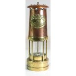 A brass & copper miners lamp, by E. Thomas & williams Ltd, embossed brass plaque 'Cambrian' No