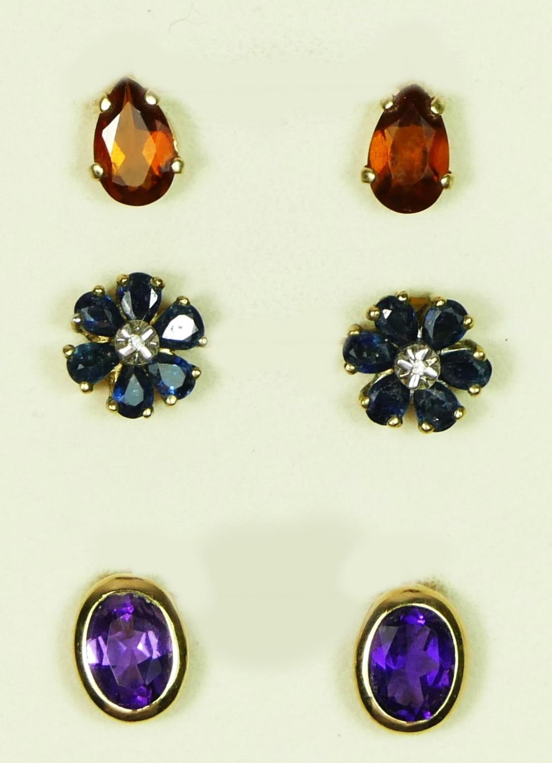 A 9ct gold pair of diamond and sapphire cluster ear studs, a citrine pair and a an amethyst pair,