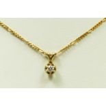 A 9ct gold and brilliant cut diamond single stone pendant, chain, 1.3gm