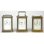 Three French mid 20th Century brass carriage clocks, white enameled dials with Roman numerals,
