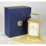 An English 8 day carriage clock, brass cased, bevel edged glass panels with enameled dial and