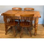 A stained pine country kitchen style table, on turned legs, 80cm x 135cm x 135cm, with four matching