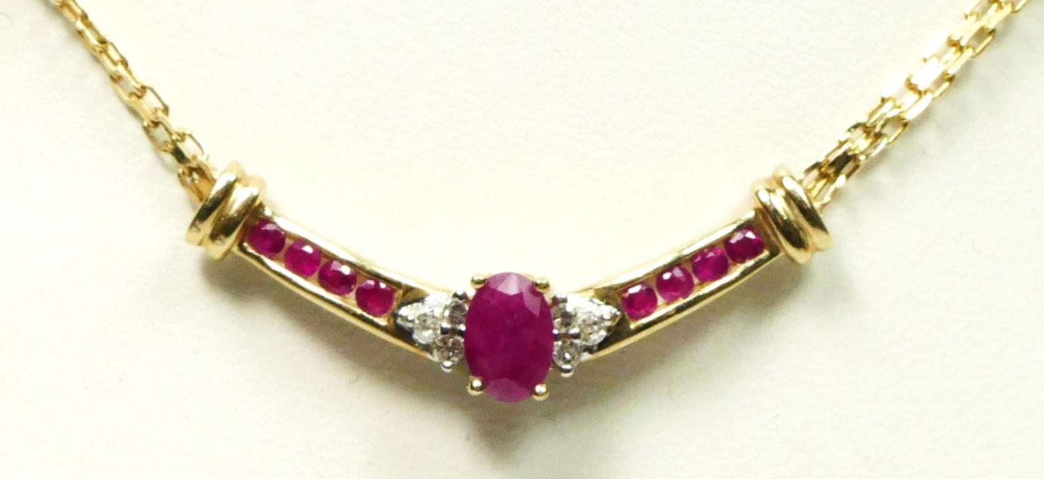 A 9ct gold ruby and diamond necklace, front 30mm, chain 42.5cm, 4.6gm
