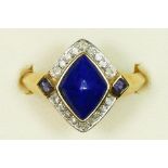 A 9ct gold, lapis lazuli and diamond dress ring, the lozenge collet set stone bordered by 18