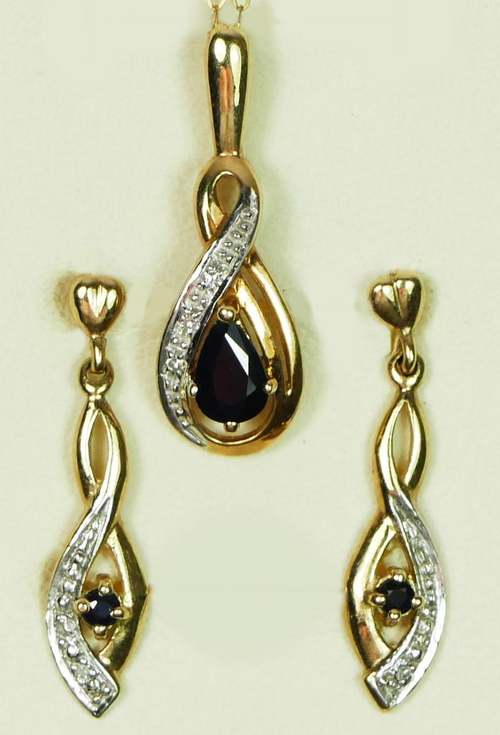 A 9ct gold sapphire and diamond pendant with matching ear rings, 2.7gm