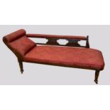 An Edwardian stained beechwood framed and upholstered chaise lounge, the padded scroll end extending